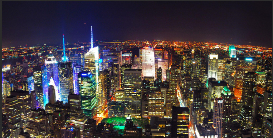 Air view of a city with skyscrapers at night