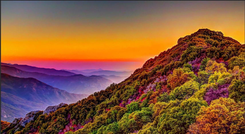 A Mountain with a sunset in background
